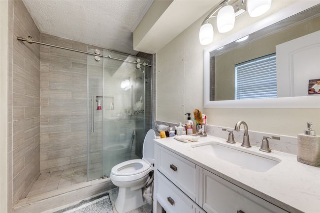 Full bath featuring vanity, a shower stall, and a textured ceiling | Image 21