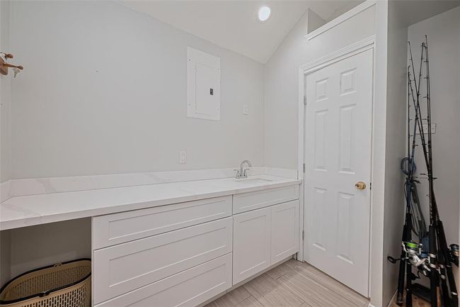 Upon entering the 1st floor you will find well-lit utility room with a door leading to a 2nd full bathroom. | Image 27