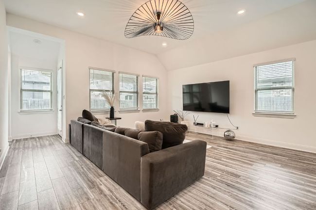 Living room with light wood-type flooring, vaulted ceiling, and recessed lighting | Image 7