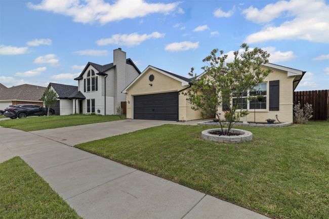View of front of property with driveway, a garage, and brick siding | Image 31
