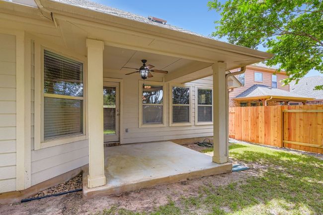 View of the back patio featuring a ceiling fan | Image 26