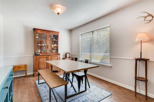 Dining space featuring wood finished floors and baseboards | Image 7