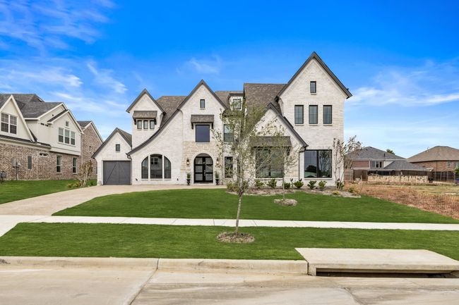 French provincial home featuring a garage and a front lawn | Image 4