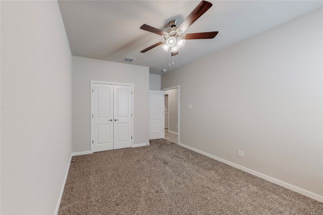 Unfurnished bedroom with carpet, baseboards, a closet, and a ceiling fan | Image 26