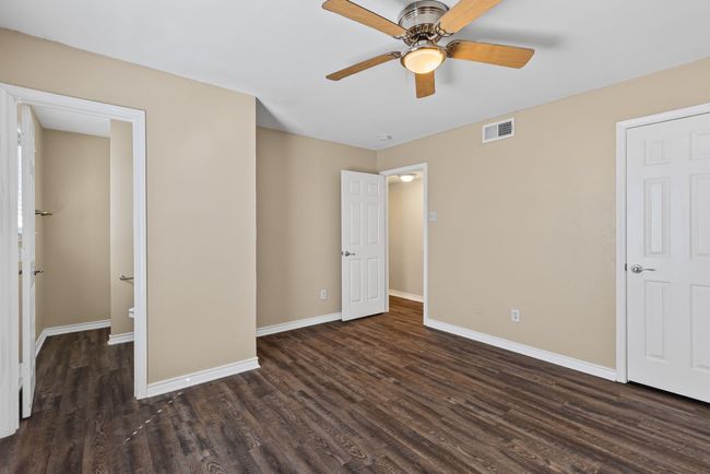 Primary bedroom featuring baseboards, visible vents, ceiling fan, and wood finished floors | Image 20