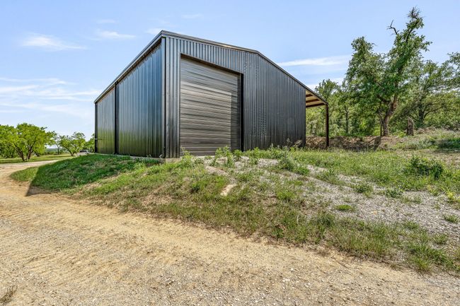 View of outdoor structure featuring driveway and an outbuilding | Image 17