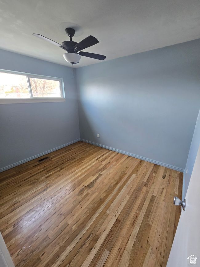 Spare room with light wood-style floors and a ceiling fan | Image 11