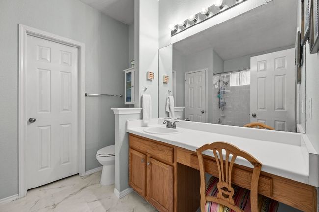 Bathroom with decorative tile flooring, vanity, and walk in closet | Image 15