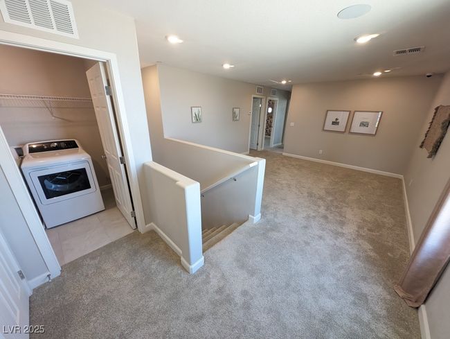 Corridor with washer / clothes dryer, light colored carpet, recessed lighting, and an upstairs landing | Image 26