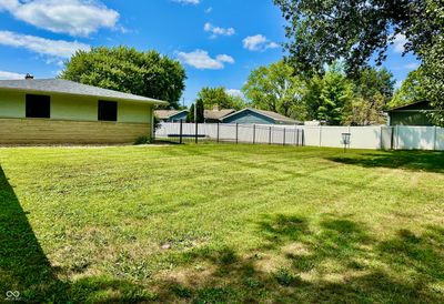 Back and side yard completely fenced with both vinyl and new black wrought iron provides an oasis for outdoor recreation. Property sits on .52 acres. | Image 3