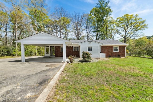 Single story home with driveway, a carport, a front yard, crawl space, and brick siding | Image 28