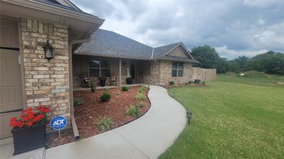 View of front facade featuring a garage, a front yard, and covered porch | Image 3