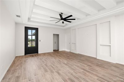 Entrance foyer with beam ceiling, ceiling fan, light wood-type flooring, and a tray ceiling | Image 3