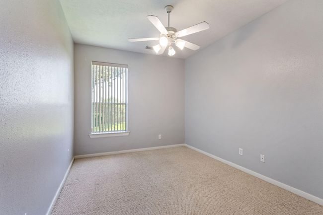 Bedroom 2 is located at the back of the house with a view to the backyard and perfectly situated next to the full bathroom. Great for a guest room or that family member that demands privacy | Image 19