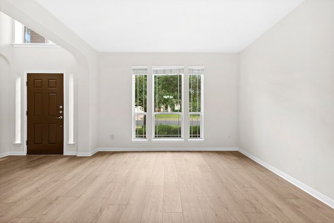 Foyer entrance with light wood-style flooring and arched walkways | Image 5