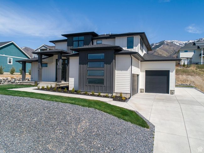 Prairie-style house with an attached garage, board and batten siding, driveway, and a mountain view | Image 68