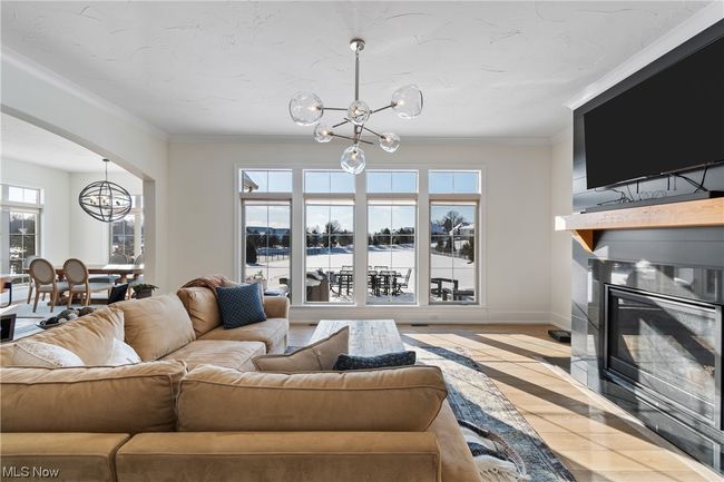 Living room with ornamental molding, plenty of natural light, and light hardwood / wood-style floors | Image 6