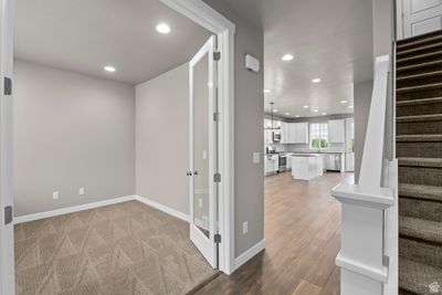 Interior space with light colored carpet and a chandelier | Image 3