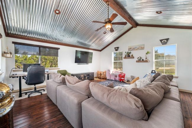 Living room featuring baseboards, ceiling fan, vaulted ceiling with beams, and wood-type flooring | Image 22