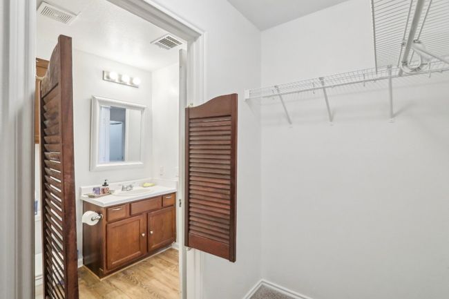 Bathroom featuring visible vents, wood finished floors, a closet, and vanity | Image 15