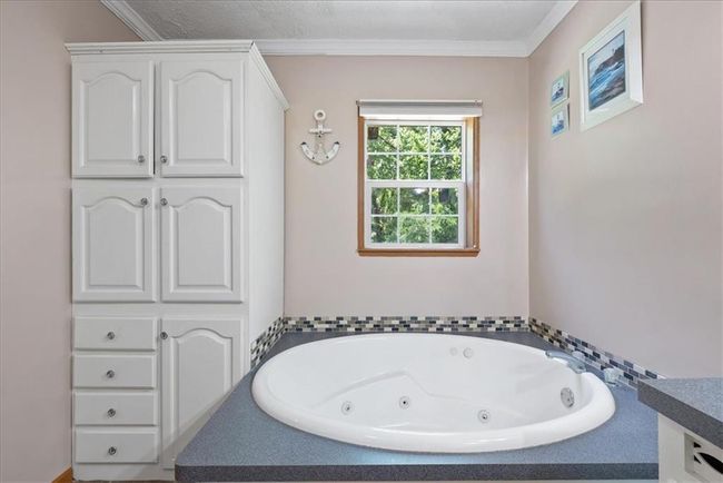 Full bath with ornamental molding and a whirlpool tub | Image 21