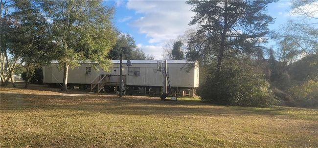 Rear of 2 bedroom, 2 bath MH, deck and entrance facing south | Image 5