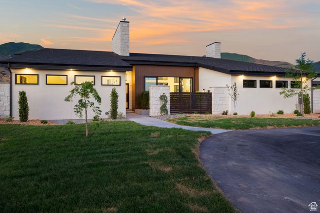 View of front facade with a chimney, stucco siding, and roof with shingles | Image 8