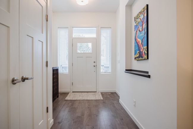 Carpeted bedroom with baseboards, lofted ceiling, a ceiling fan, a closet, and a walk in closet | Image 15
