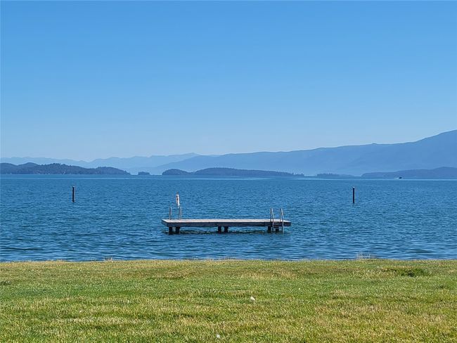 Dock area with a water and mountain view and a yard | Image 21