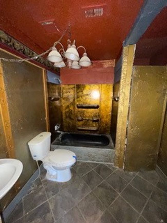Bathroom featuring a sink, a stall shower, and toilet | Image 27