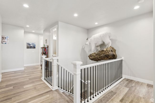 Hall featuring an upstairs landing, recessed lighting, light wood-style flooring, and baseboards | Image 9