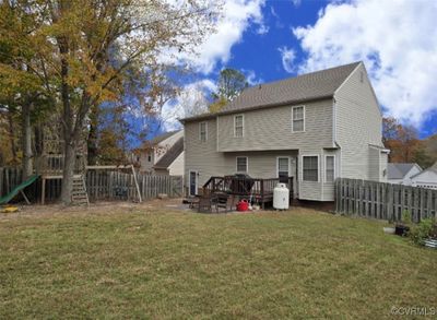 Rear view of house featuring a yard and a wooden deck | Image 3