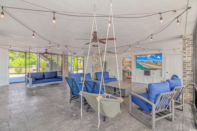 View of patio / terrace with an outdoor hangout area, a ceiling fan, and stairway | Image 37
