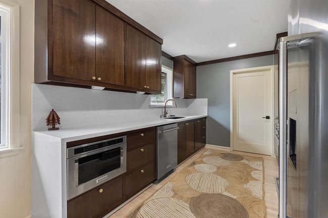 The modern design of the kitchen flow seamlessly with the rest of the home. | Image 8