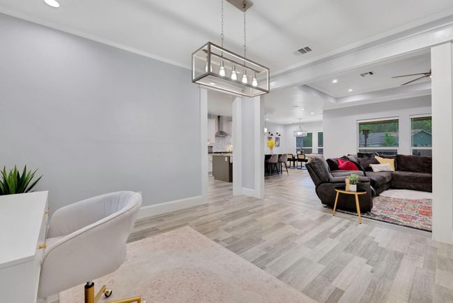Stunning open-concept view encompassing the living room, kitchen, flex space, and grand entry—perfectly designed for both elegance and functionality. | Image 11