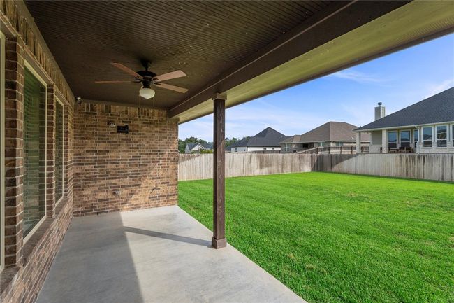 View of yard with a ceiling fan, a patio, and a residential view | Image 30