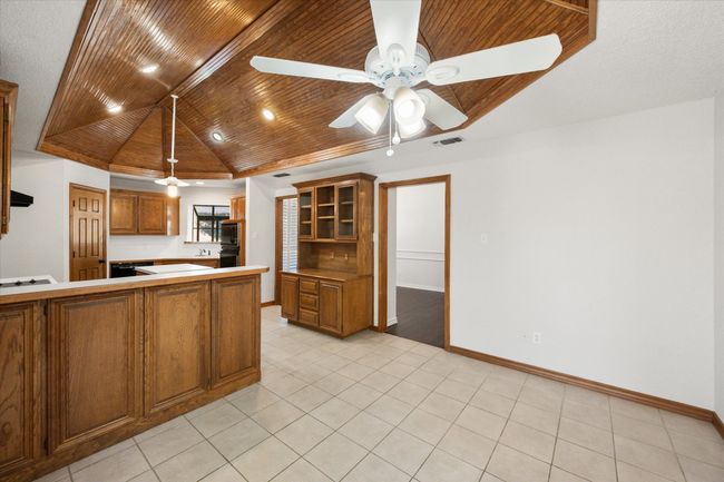 The cabinets under the breakfast bar open for easy access. | Image 26