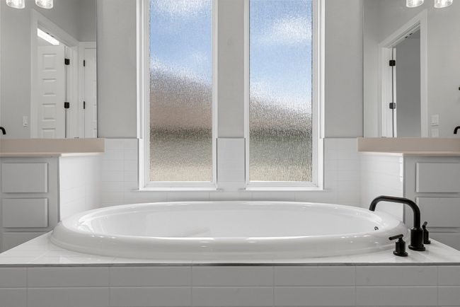 Full bathroom with a bath | Image 22