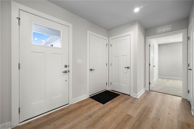 Entryway featuring visible vents, light wood-type flooring, and baseboards | Image 5