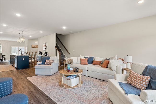 Living room featuring sink, dark hardwood / wood-style floors, and a notable chandelier | Image 23