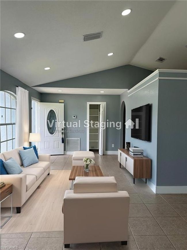 Living room with lofted ceiling, arched walkways, and recessed lighting | Image 7