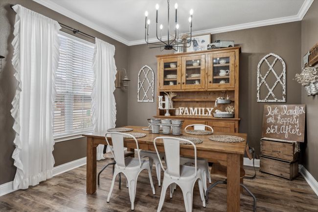 Dining room featuring an inviting chandelier, ornamental molding, and dark wood-type flooring | Image 11