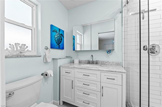 Full bathroom featuring a shower stall, toilet, and vanity | Image 14