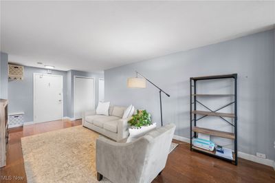 Living room with dark wood-type flooring | Image 3