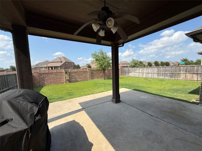 View of patio with area for grilling and a ceiling fan | Image 15