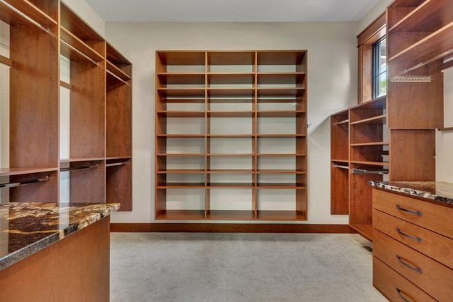 Primary bedroom with two spacious walk-in closets, offering ample storage and convenience. | Image 53