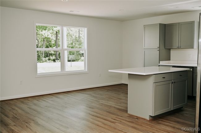 Kitchen with gray cabinets, hardwood / wood-style floors, and a center island | Image 7