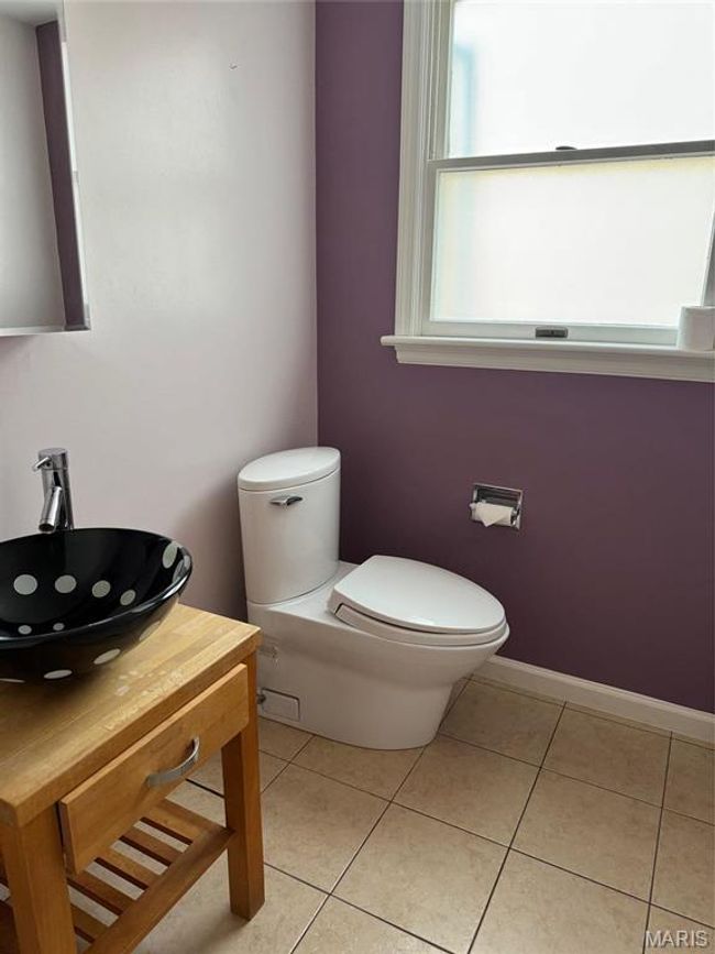 Bathroom with vanity, tile patterned floors, and toilet | Image 36