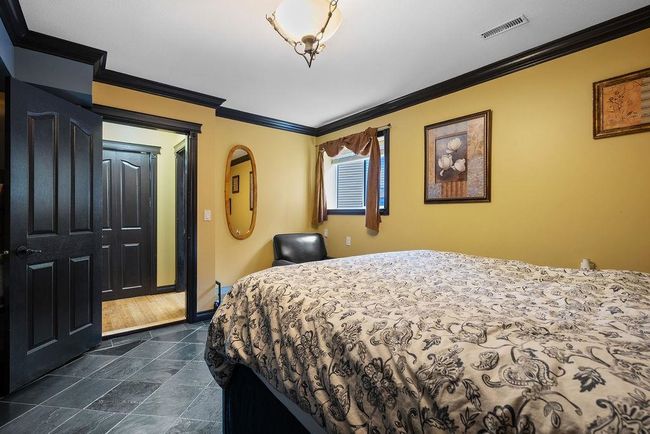 Bedroom with crown molding and baseboards | Image 26