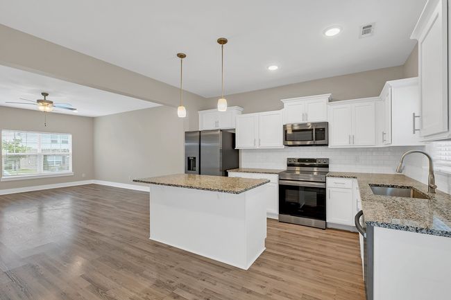 Great flow from living space through kitchen to back patio | Image 12